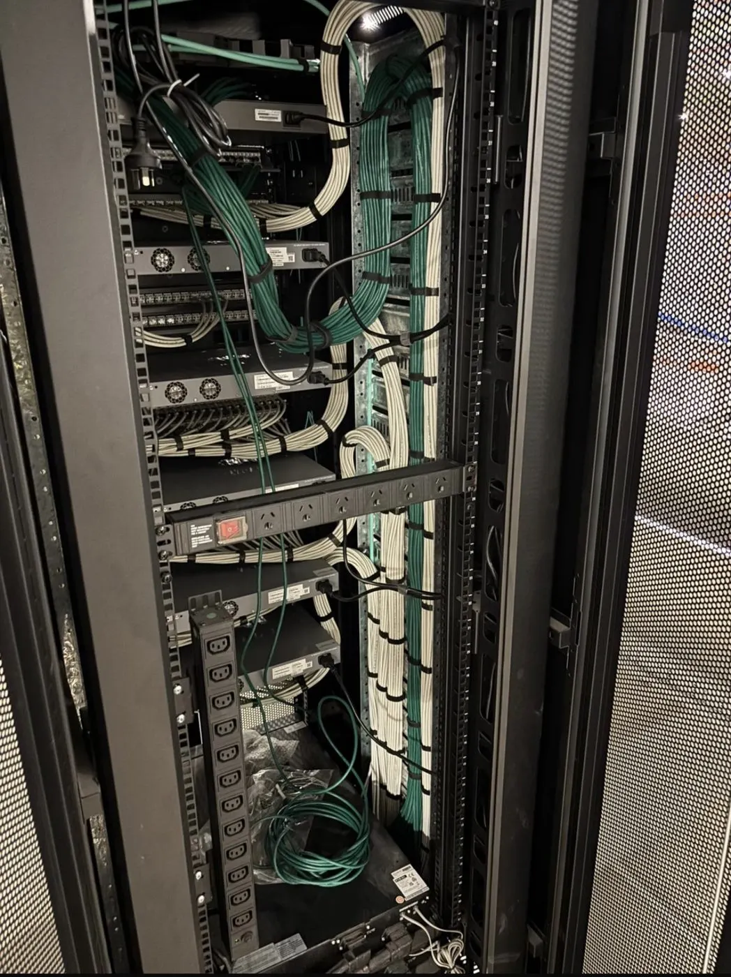 Newly installed comms rack with structured cabling, awaiting hand-off at a Sydney commercial site