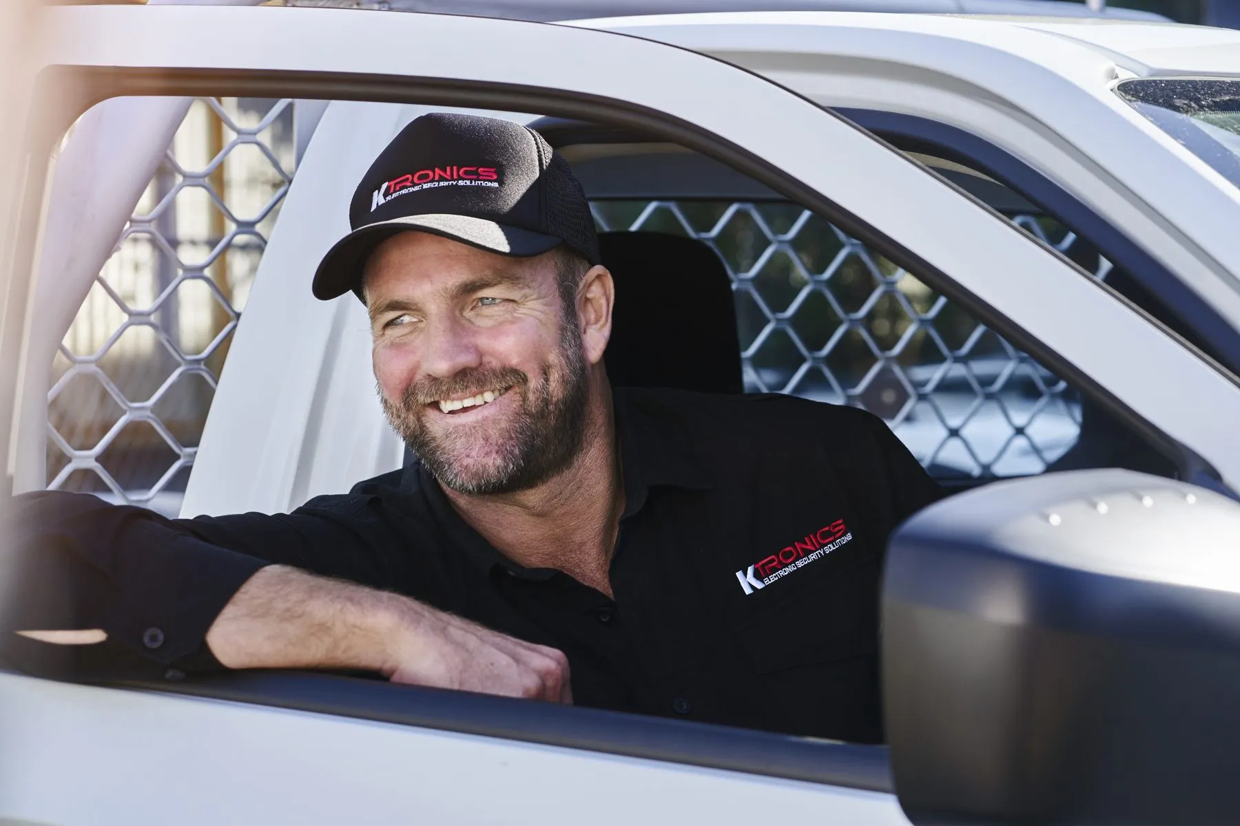 Karl Lamb, Ktronics Managing Director, in his work vehicle wearing a Ktronics uniform. Sydney commercial electronic security installer since 2003.