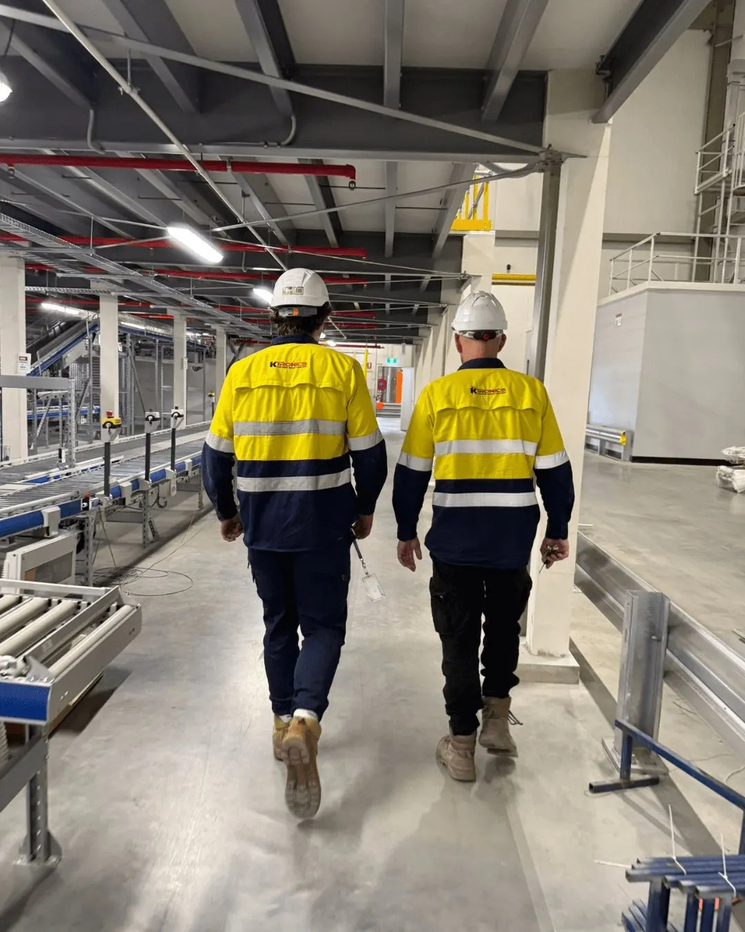 Two Ktronics technicians walking through the pharmaceutical distribution facility in Western Sydney during a security install