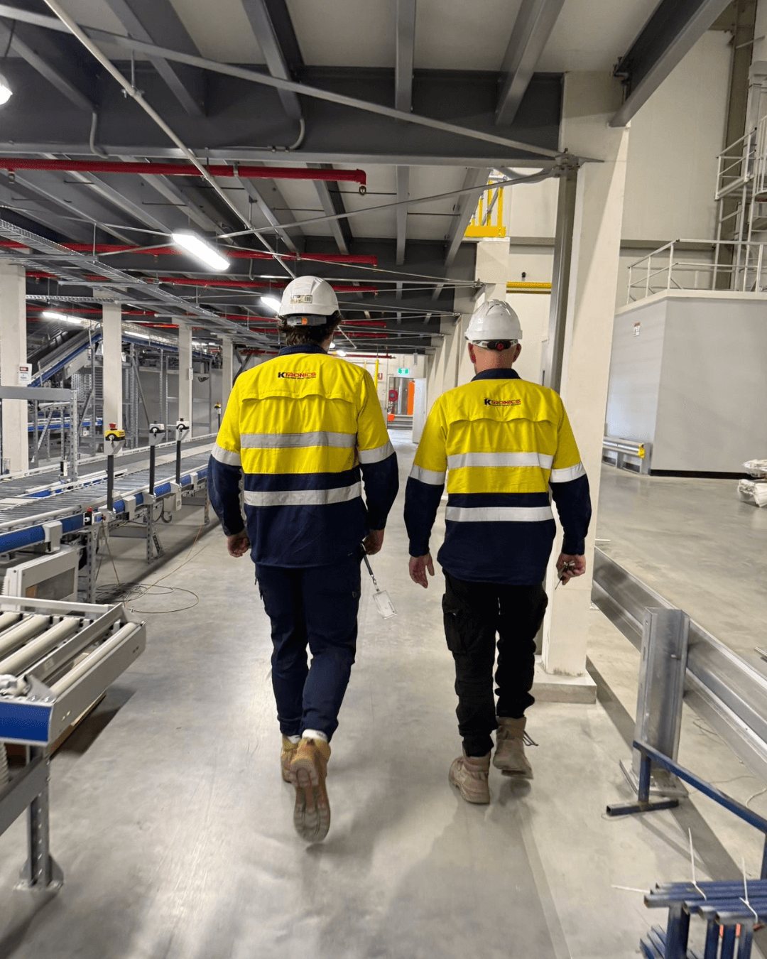 Two Ktronics technicians walking through the pharmaceutical distribution facility in Western Sydney during a security install