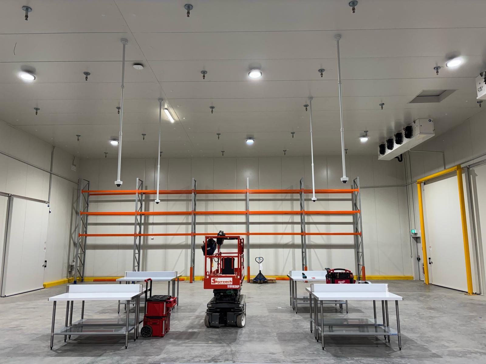 Warehouse interior with Ktronics-installed CCTV cameras and sensors mounted to the ceiling
