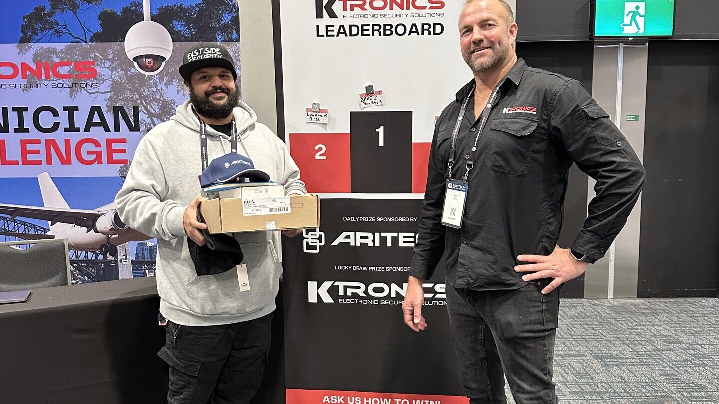 Karl Lamb at the Ktronics Leaderboard stand at SecTech New Zealand 2025
